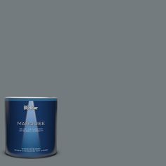 a can of behr marquee paint on a green background