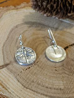 "You can find more silver treasures in my shop! Click here: https://www.etsy.com/shop/SeasideSilverJewels Or follow me on Facebook: https://www.facebook.com/SeasideSilverJewels/ The Dragonfly is a subject of intrigue everywhere it is found. You can't help but smile when you see the first one each summer. Each earring is handcrafted; all wonderfully unique and one of a kind! The ear hooks are made of sterling silver and shaped so they hang nicely and won't fall out. SIZE AND DETAIL: Earrings are Silver Symbolic Drop Earrings, Symbolic Silver Drop Earrings, Symbolic Silver Earrings With Ear Wire, Artisan Silver Nickel-free Earrings, Handmade Silver Plug Earrings As Gift, Handmade Silver Plug Earrings For Gifts, Artisan Nickel-free Silver Earrings, Small Nickel-free Sterling Silver Earrings, Silver Symbolic Earrings For Jewelry Making