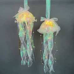 two jellyfishs with lights attached to them