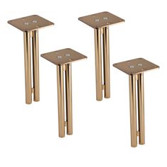 three gold metal tables with square bases and small white dots on the top, set of 3