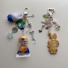 two key chains with charms attached to them