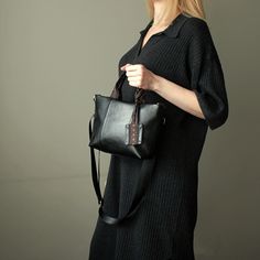 "Black crossbody tote bag small size city style handmade. Mini shoulder bag black color faux leather. Height:18 cm  ( 7,09 \" ) Top Width:29 cm  ( 11,41 \" ) Bottom Width: 21 cm ( 8,26 \" ) Depth:8 cm   ( 3,15 \" ) Strap:115 cm  ( 45,27 \" ) adjustable Black mini tote cross bag made of faux leather. Small black handbag has cotton lining, 3 pockets inside, detachable adjustable strap nylon black. The bag is decorated with a ribbon with a floral pattern. The front of the bag is decorated with two seams, the back of the bag is decorated with a ribbon with a pattern. The bag can be worn both on one side and on one side.  The handbag is decorated with a keychain. Fashion mini black handbag for women. Black small shoulder bag vegan leather handmade. Unique small cross tote bag black vegan leathe Leather Satchel Box Bag With Adjustable Handle, Trendy Leather Satchel With Adjustable Handle, Leather Shoulder Box Bag With Adjustable Handle, Leather Box Shoulder Bag With Adjustable Handle, Leather Tote Box Bag With Adjustable Handle, Black Leather Hobo Bag With Top Carry Handle, Crossbody Box Bag With Top Carry Handle, Black Top Handle Satchel With Handles, Trendy Leather Box Bag With Adjustable Handle