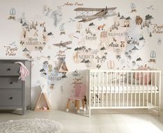 a baby's room with an airplane theme on the wall and a crib