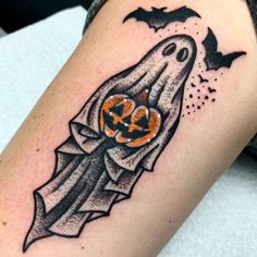 a halloween ghost tattoo on the arm