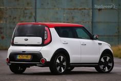 the rear end of a white and red mini countryman parked in a parking lot