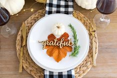 a white plate topped with an autumn decoration