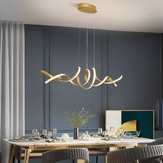 an elegant dining room with gold accents and modern chandelier hanging over the table