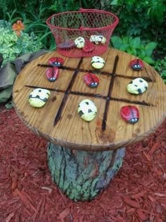 a wooden table topped with cupcakes on top of a tree stump