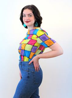 "This is a sweet colorful 90s vintage \"Notations\" top! It's a bright color block geometric square print in shades of pink, blue, yellow, purple and orange with black grid lines. A short sleeved pullover, it has a boxy shape, a high round neckline, no shoulder pads, and it closes with a back keyhole neckline and a black button and loop. The fabric is a lightweight silken polyester. This top is in very good clean vintage condition, no flaws noted. The label says \"Notations, Size S, 100% Polyest 90s Color Block, Rainbow Vintage, Rainbow Pastel, 90s Colors, Blue Rainbow, Keyhole Neckline, Color Block Top, Square Print, Short Sleeve Pullover