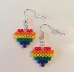 a pair of earrings made out of legos