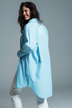 Step into summer with style in our Light Blue Oversized Stripe Blouse, a blend of casual elegance and breezy comfort, making it an ideal choice for your sunny day adventures. Lightweight and Airy Fabric: Made from 100% Polyester, this blouse is designed to offer both comfort and durability, perfect for those warm, sunny days. Refreshing Color and Design: Adorned with classic white stripes set against a serene light blue background, this blouse offers a refreshing aesthetic suitable for any summe Spring Tops With Vertical Stripes And Shirttail Hem, Chic Vertical Stripes Blouse For Day Out, Casual Vertical Stripes Blouse For Day Out, Vertical Stripes Relaxed Fit Top For Day Out, Relaxed Blue Summer Shirt, Relaxed Fit Vertical Stripes Top For Day Out, Relaxed Fit Vertical Stripe Tops For Day Out, Chic Oversized Striped Top, Chic Vertical Stripes Blouse For Spring