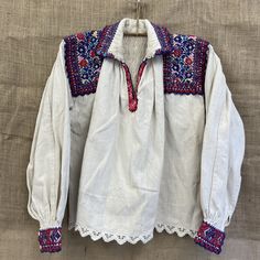 beautiful handmade 1970s traditional folk Romanian blouse with detailed embroidery  made in ARAD Transylvania , Romania  hemp traditionally mens blouse but can also be for a woman. size M / L Each item is special and unique so may have beautiful little imperfections :) message me if you have any questions xx Traditional White Peasant Top For Fall, Folk Style Peasant Top With Boho Collar, Folk Style Cotton Peasant Top With Embroidered Sleeves, Folk Style Embroidered Long Sleeve Peasant Top, Folk Style Peasant Top With Embroidered Sleeves For Festival, Embroidered Long Sleeve Folk Peasant Top, Spring Folk Blouse With Woven Motifs, Traditional Fall Peasant Top With Multicolor Embroidery, Traditional Peasant Top With Embroidered Sleeves For Festivals