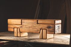 a wooden bench sitting on top of a table