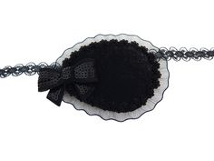 a black and white doily with a bow on it