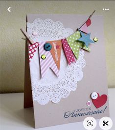 a handmade card with an image of bunting flags and buttons on the front