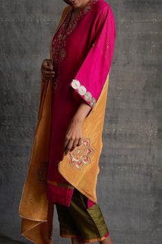 Pink raw silk kurta with floral, zari, resham, thread and gota embroidery. Comes with olive green pant and a dupatta.
Components: 3
Pattern: Embroidered
Type Of Work: Floral, Zari, Resham, Thread, Gota
Neckline: V Neck
Sleeve Type: Three quarter
Fabric: Raw silk
Color: Pink
Other Details: 
Attached lining
Length:
Kurta: 42 inches
Pant: 37 inches
Model Height: 5ft 8inches, wearing size M
Occasion: Sangeet - Aza Fashions Gota Embroidery, Kurta Pant Set, Olive Green Pants, Silk Kurta, Kurta With Pants, Indian Outfit, Green Pants, Pant Set, Embroidered Silk