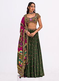 Elevate your ethnic wardrobe with this Green Embroidered Lehenga Set, a perfect blend of tradition and contemporary elegance. Crafted from luxurious crepe fabric, the flowy green lehenga is adorned with delicate pink polka dots, adding a subtle yet charming appeal. Paired with a stunning hand-embroidered blouse featuring intricate detailing and vibrant threadwork. The look is completed with a contrasting rani pink dupatta, designed with bold motifs and a rich color palette that beautifully enhan Rani Pink Dupatta, Pink Dupatta, Rani Pink, Green Lehenga, Vacuum Storage, Embroidered Lehenga, Indian Wedding Wear, Lehenga Blouse, Sleeves Blouse