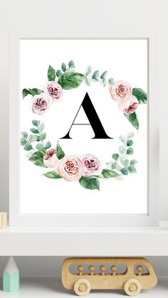 a floral monogrammed print with the letter a on it in front of a white shelf