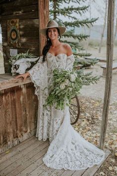 a woman in a white dress and hat standing on a porch