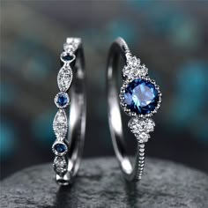 two wedding rings with blue and white stones