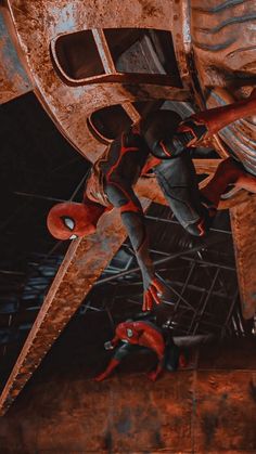 two people are climbing up the side of a building with spider - man costumes on