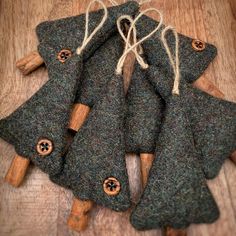 several pieces of felt with buttons on them sitting on a wooden table next to some string