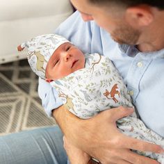 a man holding a baby in his arms