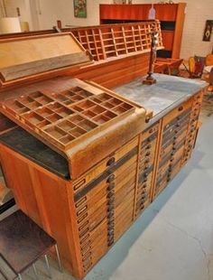 an old wooden chest with many drawers and chairs around it in a room filled with furniture