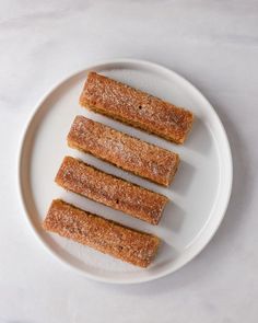 four pieces of food on a white plate