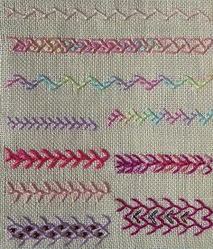 a close up of a piece of cloth with different colored stitches on it and an arrow in the middle