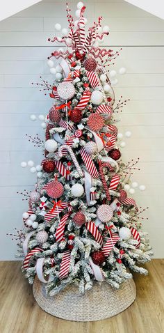 a christmas tree decorated with red, white and silver ornaments