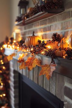 a mantel with candles and pumpkins on it