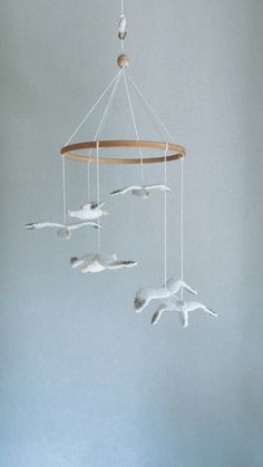 a white bird mobile hanging from the ceiling