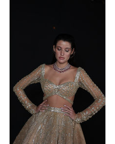 Light Gold Lehenga Set - Bora Honey's Indulge in the allure of our bespoke Champagne Gold Lehenga, a regal ensemble meticulously crafted over 60-90 days. The combination of luxurious tulle and satin creates a breathtaking silhouette, while the Choli Blouse accentuates modern elegance with a touch of tradition. Embellished with stones, crystals, sequins, and Japanese cut-dana, this Lehenga is a shimmering masterpiece that captures the essence of timeless opulence. Every element is thoughtfully pl Glamorous Fitted Organza Choli, Elegant Formal Organza Lehenga, Luxury Fitted Gown For Festive Occasions, Luxury Fitted Gown For Festive Season, Fitted Luxury Gown For Festive Season, Festive Luxury Fitted Gown, Elegant Hand Embellished Sharara For Formal Occasions, Designer Fitted Choli For Party, Designer Fitted Dress For Reception