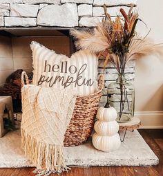 a fireplace with some pillows and other decorations in front of it on a rug next to a fire place