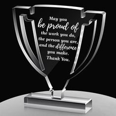 a black and white photo of a trophy that says, may you be proud of the work you do