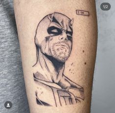 a black and white photo of a man's arm with a batman tattoo on it