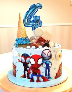 a spiderman themed birthday cake on a table