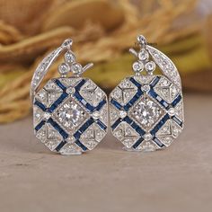 Antique Edwardian 14K White Gold Earrings/ Floral Ear Wire Earrings/ Edwardian Sapphire Earrings/ Round White Diamond Engagement Earrings 💎 𝐄𝐀𝐑𝐑𝐈𝐍𝐆𝐒 𝐈𝐍𝐅𝐎𝐑𝐌𝐀𝐓𝐈𝐎𝐍: ✪ All Stone Type: Simulated Diamond ✪ All Stone Shape: Round Cut  ✪ Color: D/E (Colorless) ✪ Clarity: IF (Internally Flawless) ✪ Cut Grade: Excellent ● 𝐌𝐄𝐓𝐀𝐋 𝐃𝐄𝐓𝐀𝐈𝐋𝐒: ✪ Metal Type:- 𝟗𝟐𝟓 𝐒𝐢𝐥𝐯𝐞𝐫 / 𝟗𝟑𝟓 𝐀𝐫𝐠𝐞𝐧𝐭𝐢𝐮𝐦 𝐬𝐢𝐥𝐯𝐞𝐫/ 𝟏𝟎𝐊𝐓/𝟏𝟒𝐊𝐓/𝟏𝟖𝐊𝐓 𝐒𝐨𝐥𝐢𝐝 𝐆𝐨𝐥𝐝/𝗣𝗹𝗮𝘁𝗶𝗻𝘂? Art Deco Hallmarked Drop Earrings, Heirloom Style Drop Earrings, Art Deco Drop Diamond Earrings For Anniversary, Art Deco Diamond Cut Earrings For Wedding, Victorian Drop Earrings For Anniversary, Art Deco Diamond Cut Earrings, Art Deco Diamond Cut Wedding Earrings, Hallmarked Art Deco Earrings For Anniversary, Art Deco Round Pierced Earrings