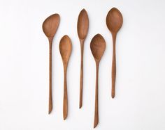 four wooden spoons are shown next to each other on a white surface with measurements