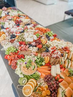 a long table filled with lots of different types of food on top of each other