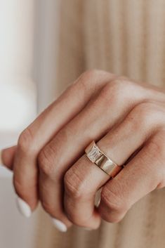 a woman's hand with a ring on it