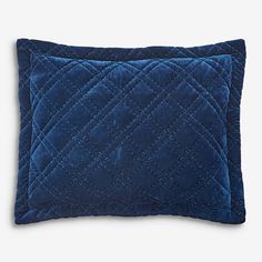 two blue velvet pillows with diamond quilting on the front and back, one in dark blue