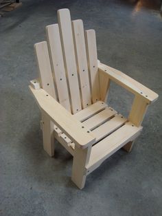 a wooden chair sitting on top of a cement floor