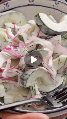 a bowl filled with cucumbers and radishes on top of a table