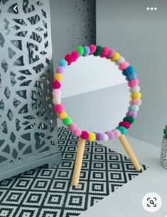 a mirror sitting on top of a table next to a potted plant