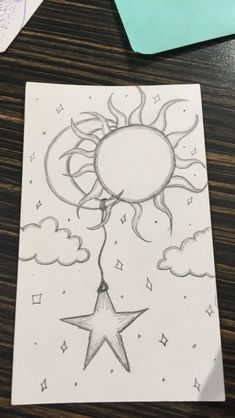 a drawing of the sun and stars on paper