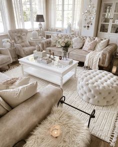 a living room filled with lots of furniture and decor on top of a white rug