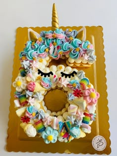 a decorated cake with an unicorn face on it