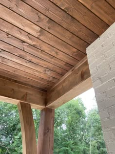 an outdoor covered patio area with wood beams